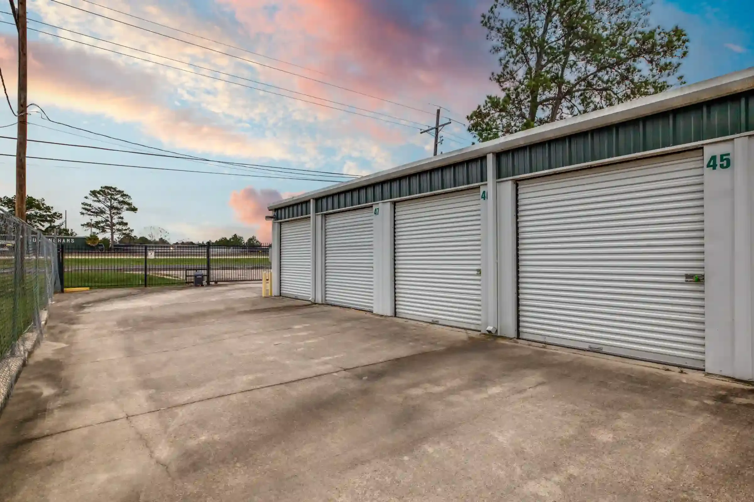 fenced storage facility with roll up doors and drive up access