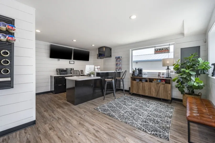 Interior of an office space with a tall counter bar and entertainment center.