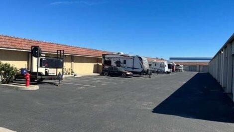 rv camper parked in front building in parking lot