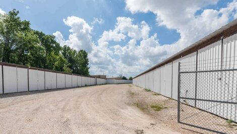 row of self storage units with drive up with a gate entry