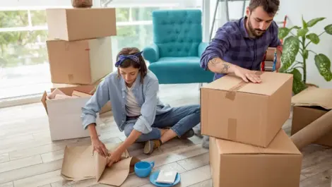 man and woman tapping up storage boxes