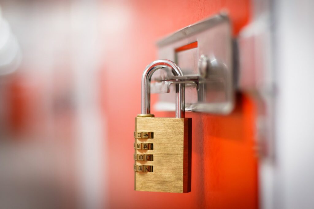 A metal lock latched onto a storage unit door.