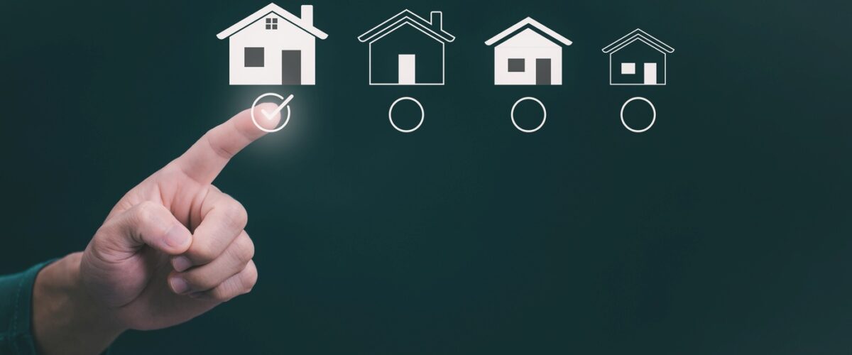 A person choosing a house icon with a finger to resemble choosing a space.
