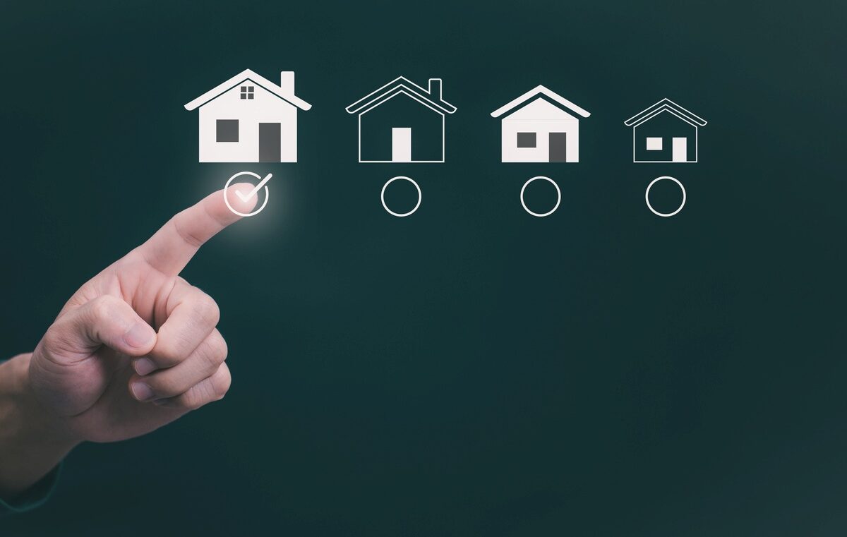 A person choosing a house icon with a finger to resemble choosing a space.