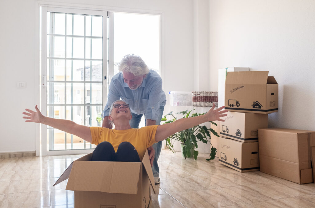 A senior couple enjoying a fun break during a home move.