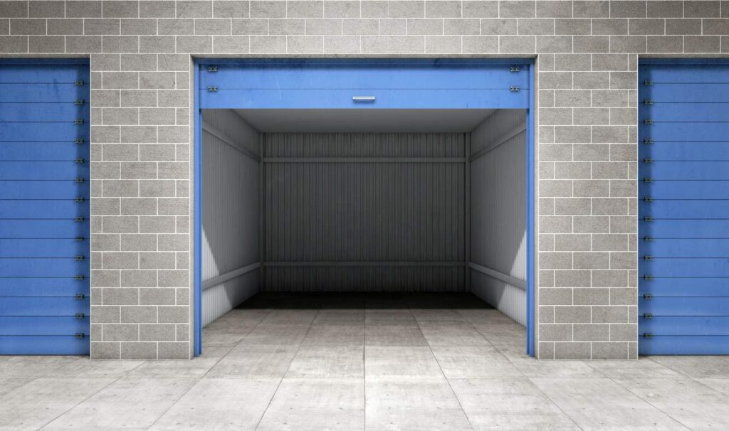 An open self storage unit with blue rolling doors.
